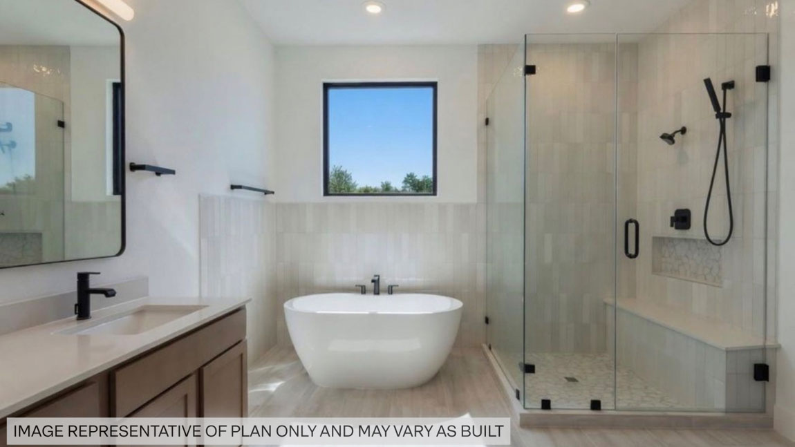 Primary bathroom with super shower with tiled wall and semi frameless glass in Pinehurst  TX