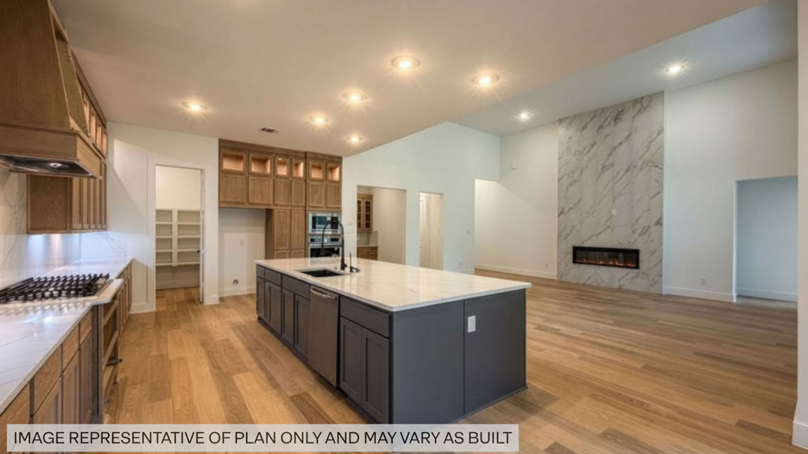 Kitchen with stainless steel appliances, quartz countertops and modern hardware and an island and vinyl floor