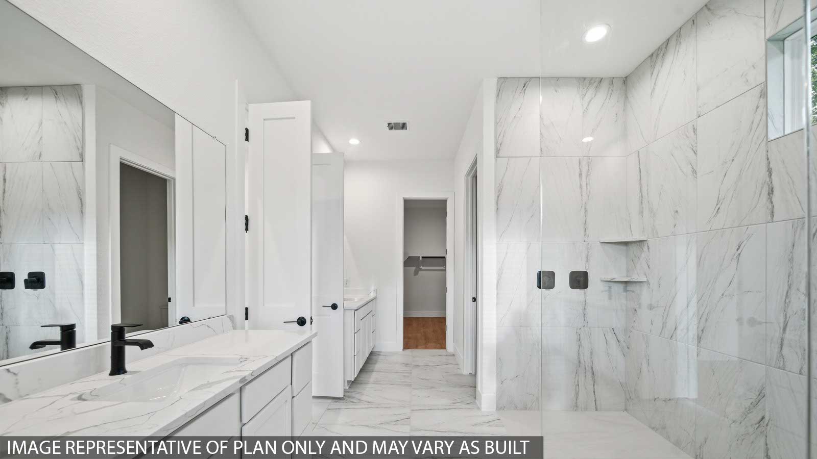 Primary bathroom with super shower with tiled wall and semi frameless glass in Pinehurst  TX