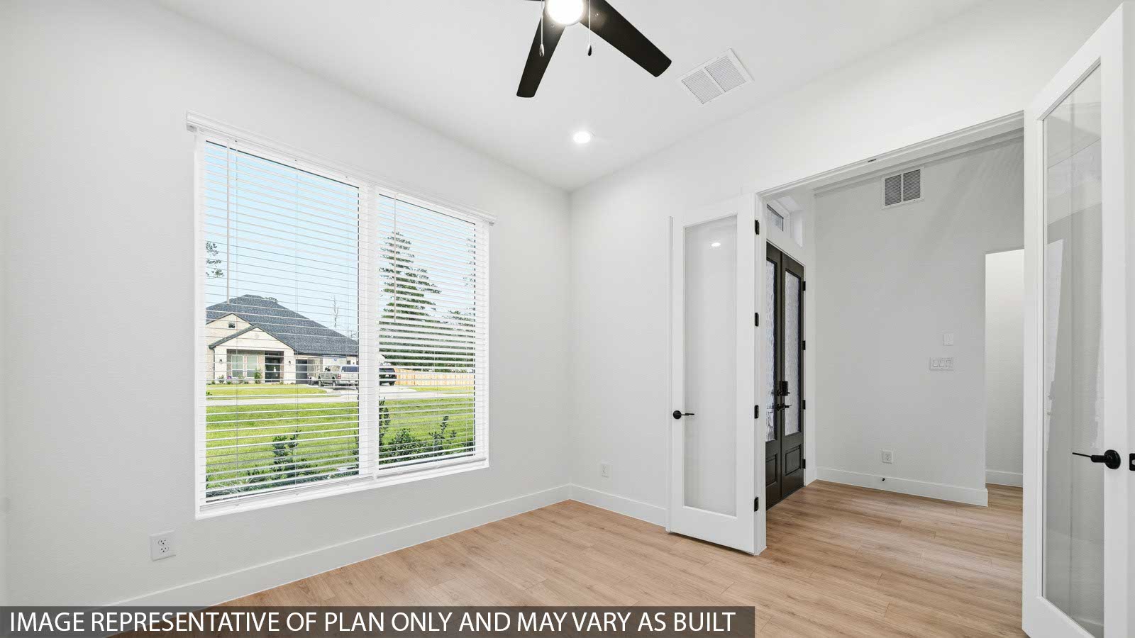 Second level secondary bedroom with carpet flooring and bright window