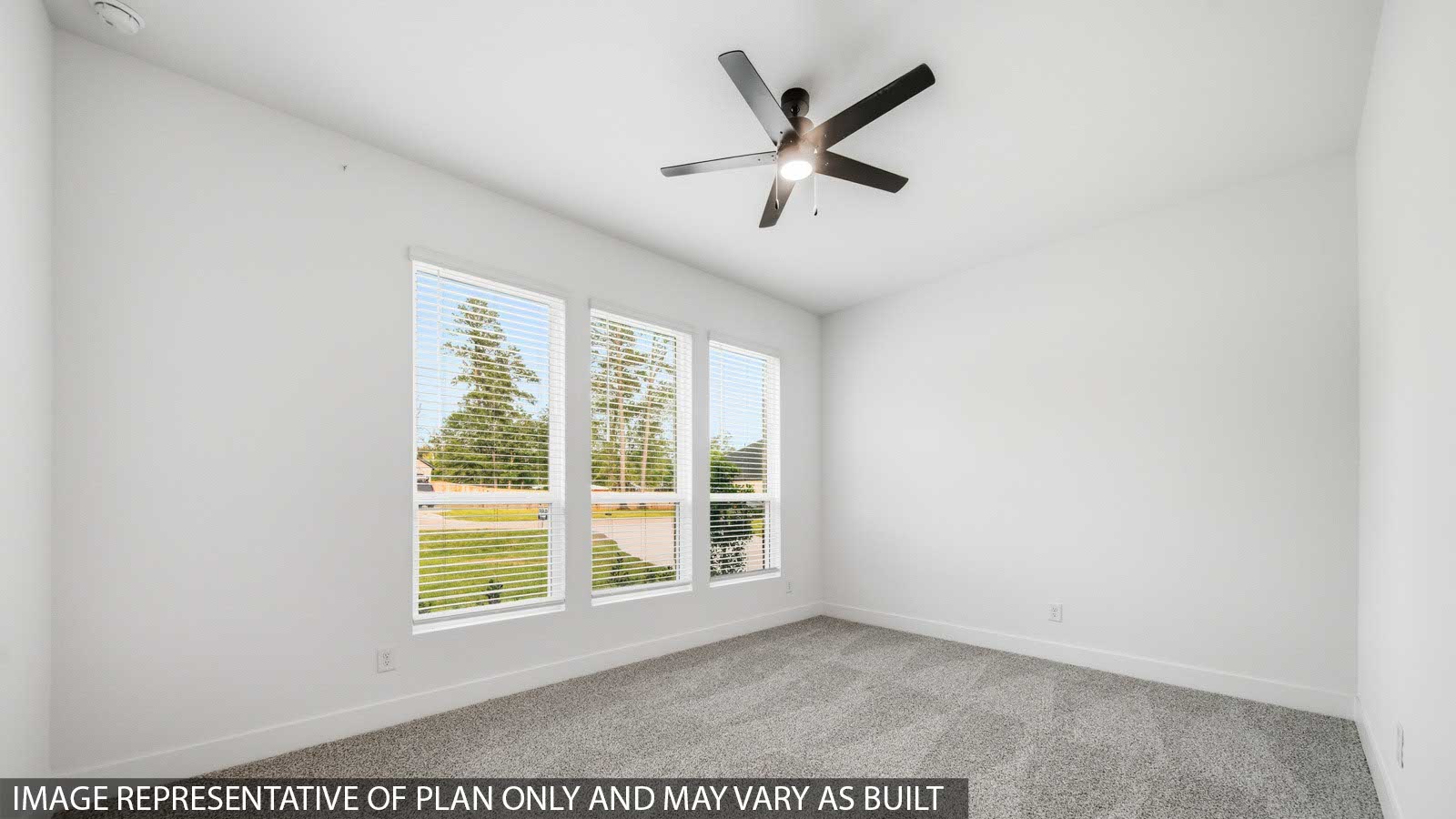 Second level secondary bedroom with carpet flooring and bright window