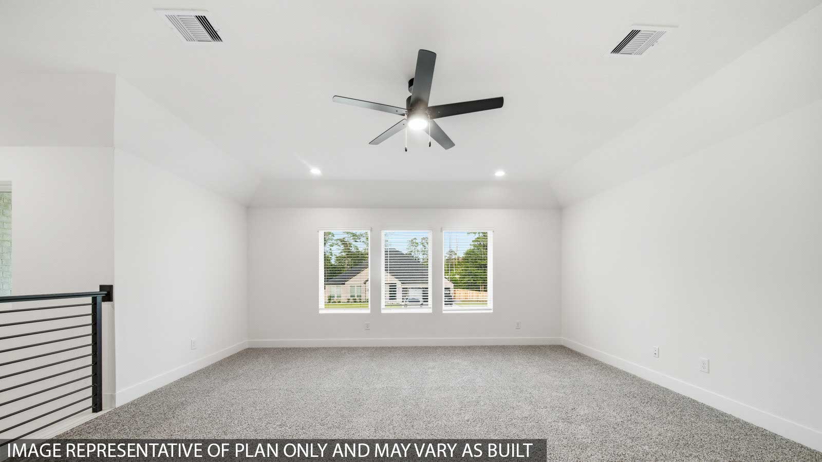 Second story game room with carpet flooring with bright windows in this multi functional space in Pinehurst TX