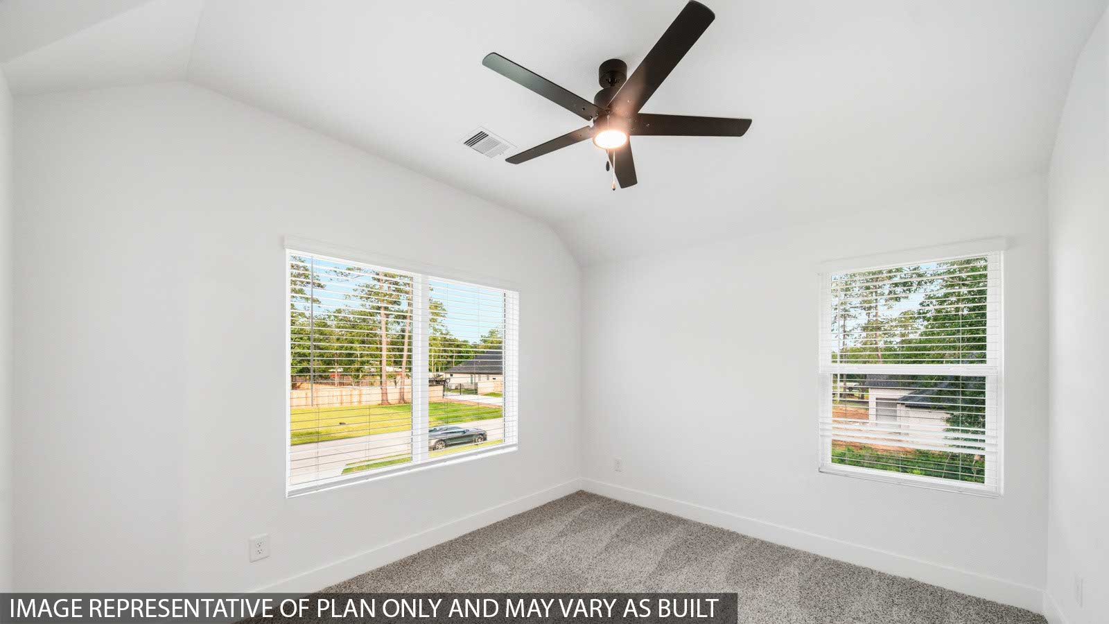 Second level secondary bedroom with carpet flooring and bright window