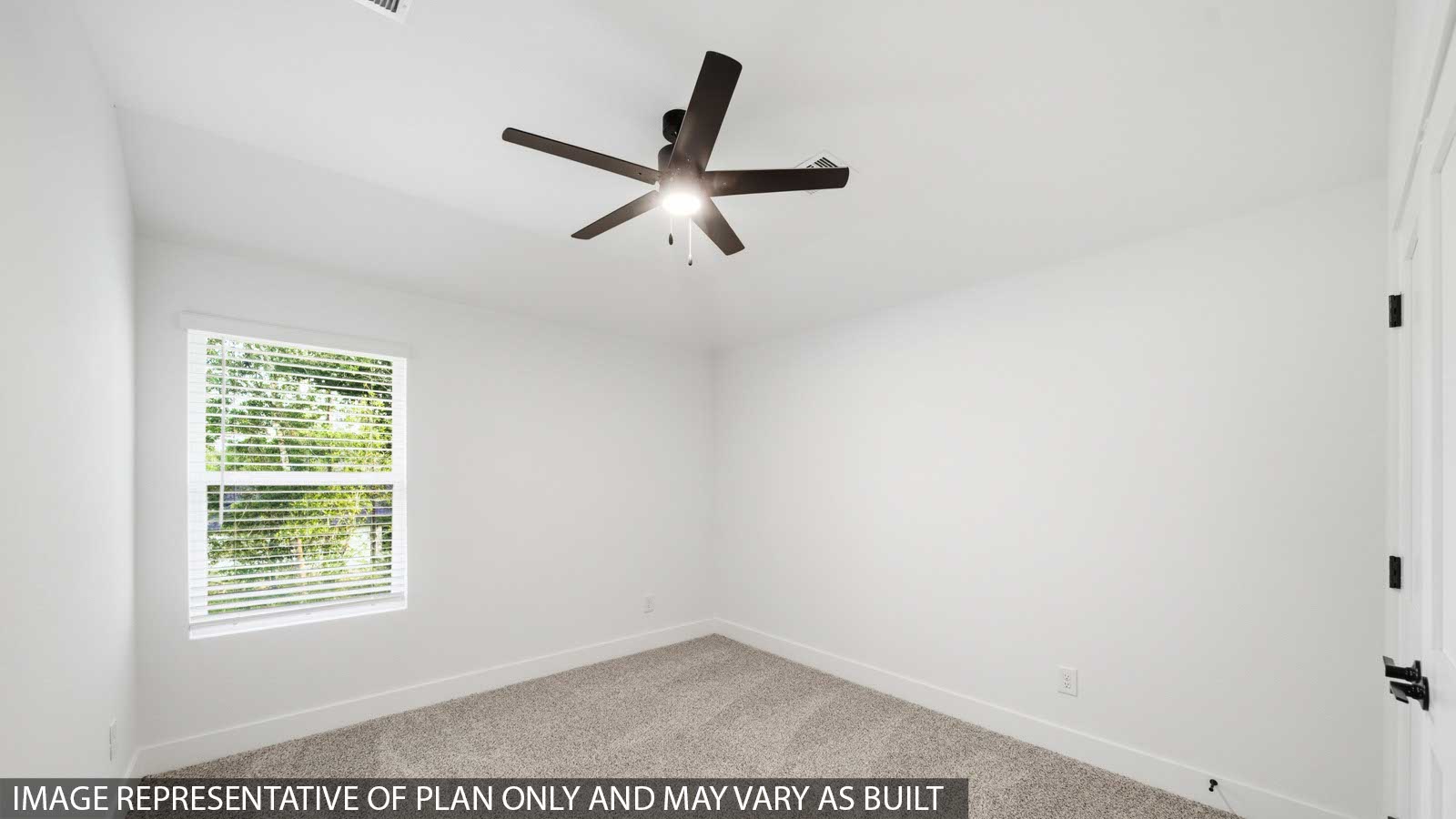 Second level secondary bedroom with carpet flooring and bright window