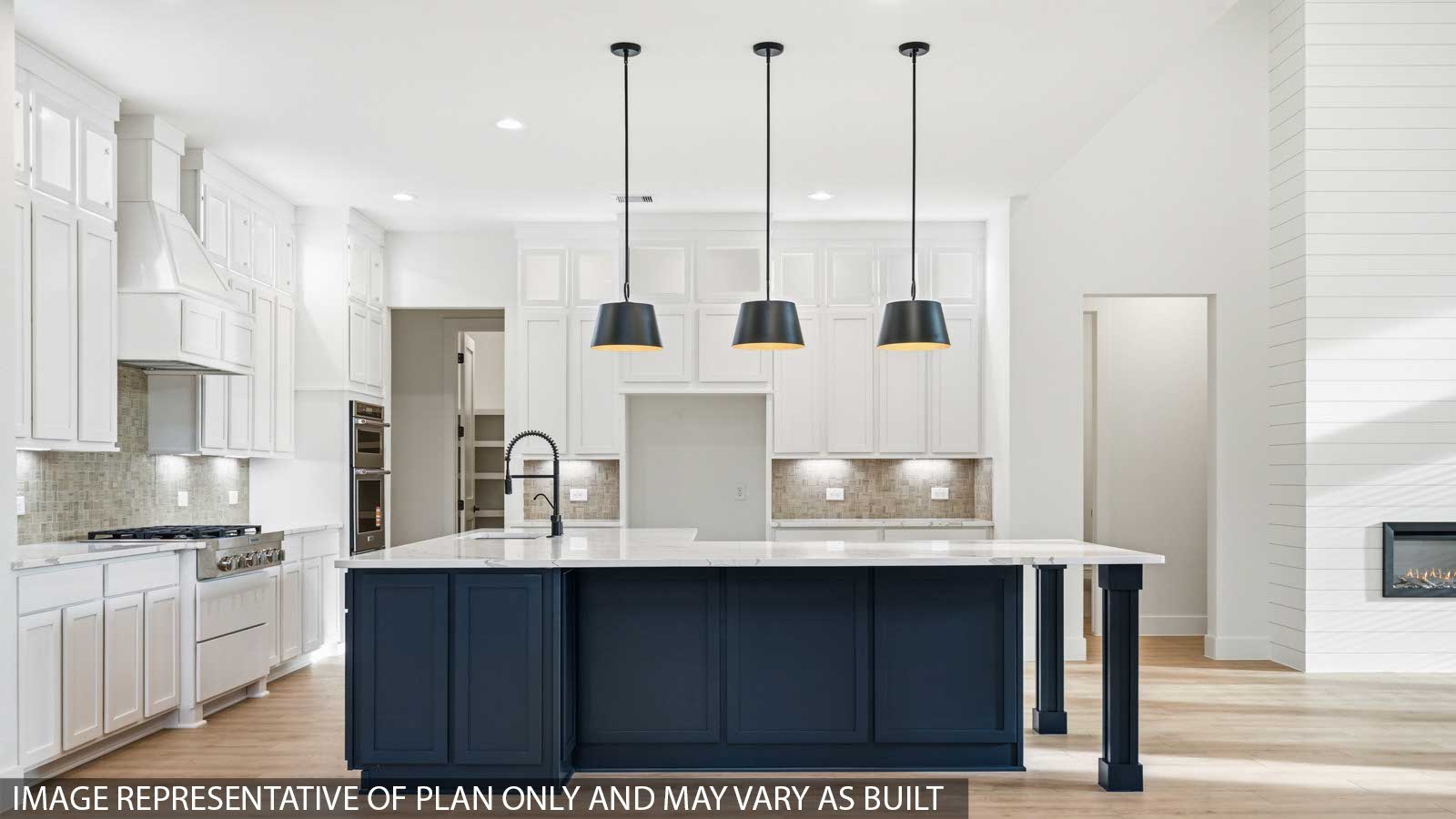 Kitchen with stainless steel appliances, quartz countertops and modern hardware and an island and vinyl floor
