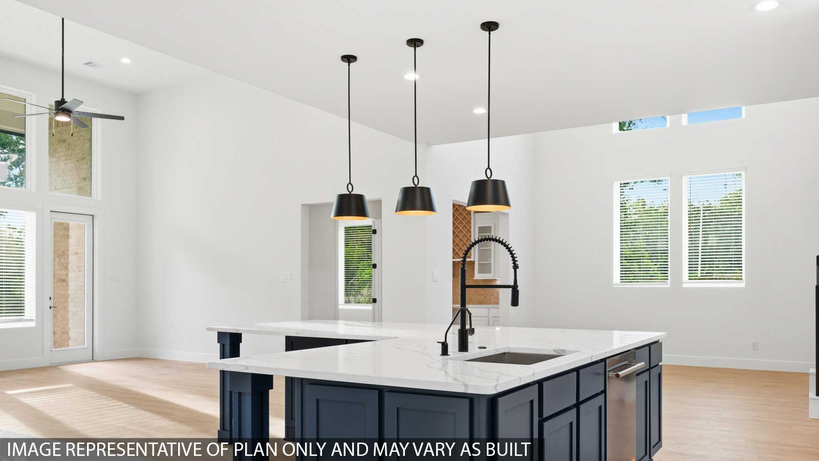 Kitchen with stainless steel appliances, quartz countertops and modern hardware and an island and vinyl floor