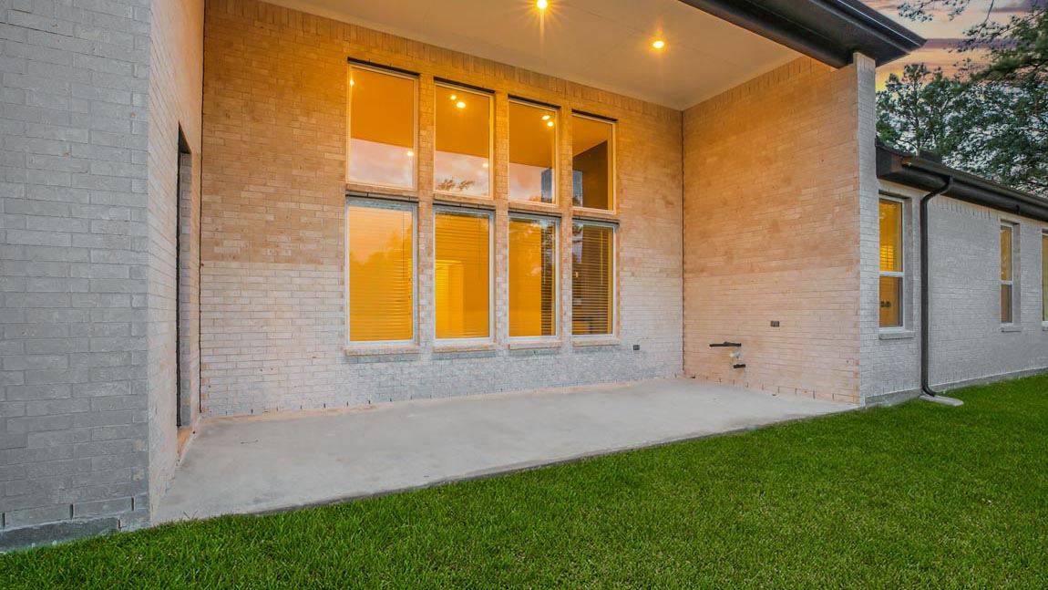covered patio with 4 sides brick and overhead lighting
