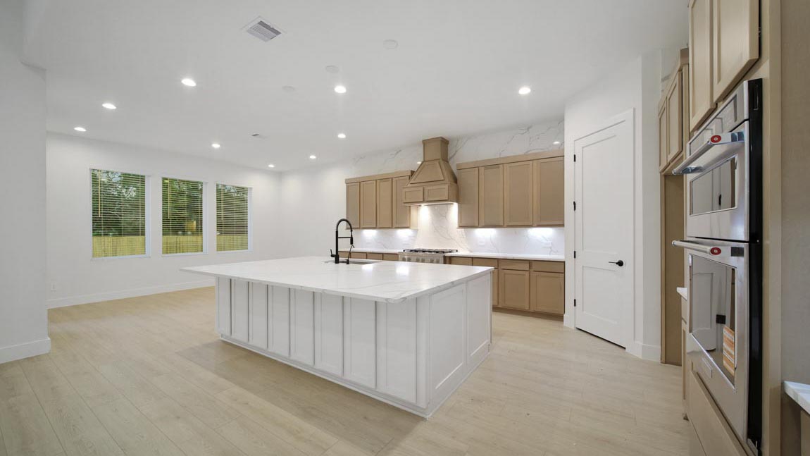 L- shaped kitchen with an island and quartz counter tops