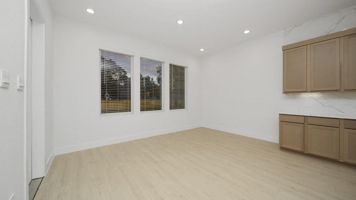 Dining area with vinyl flooring located off from the living room area in Pinehurst TX