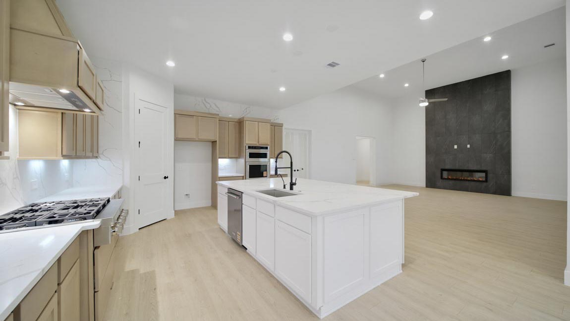L- shaped kitchen with an island and quartz counter tops