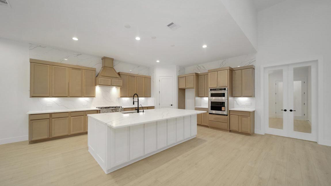 L- shaped kitchen with an island and quartz counter tops