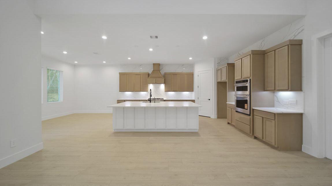 L- shaped kitchen with an island and quartz counter tops
