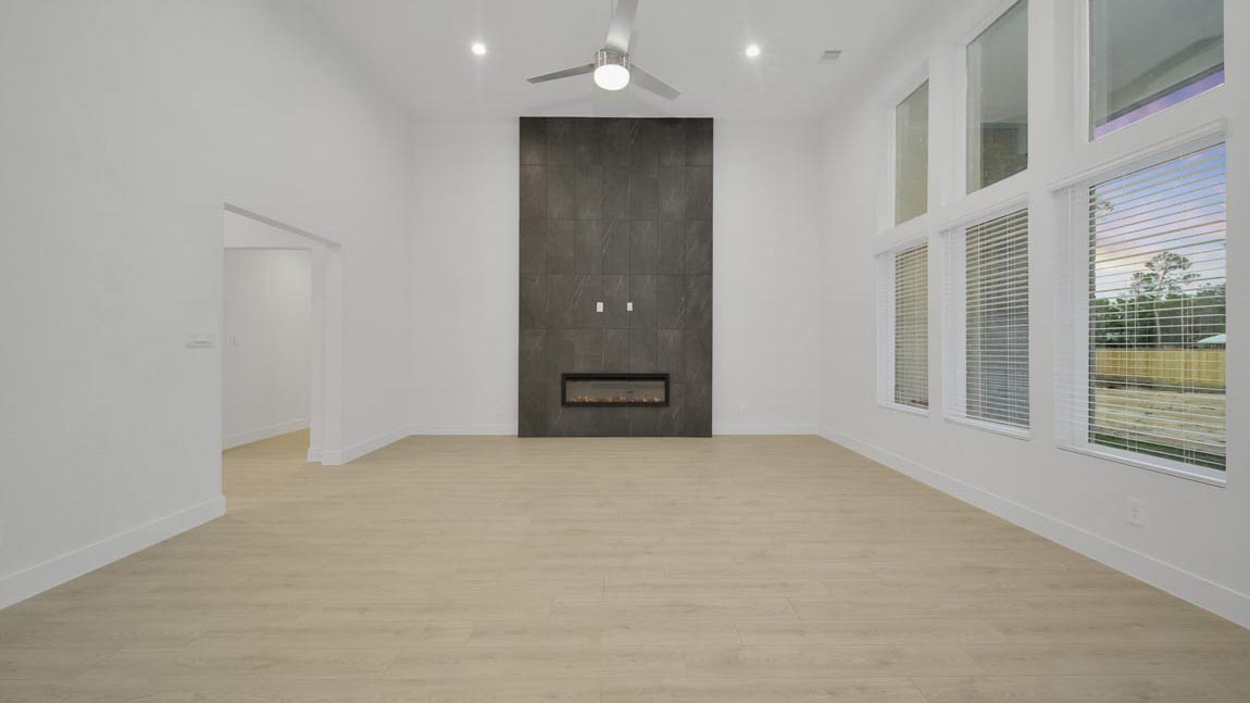 Spacious living area with vinyl flooring