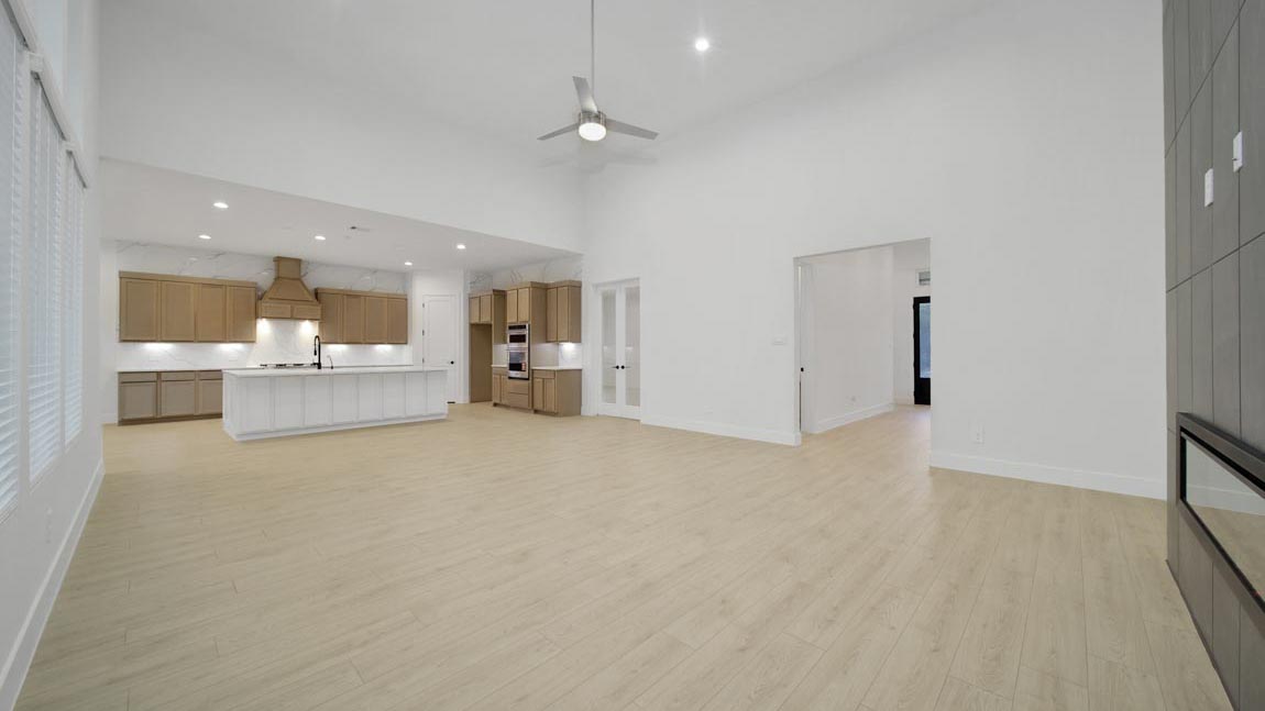 Spacious living area with vinyl flooring