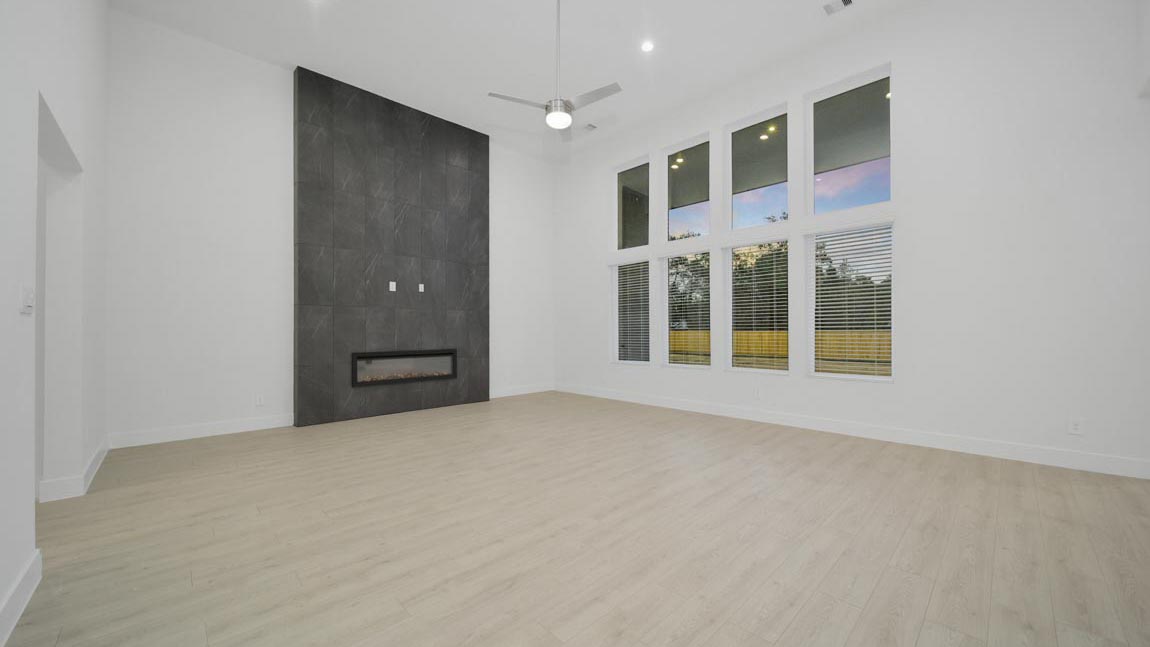 Spacious living area with vinyl flooring