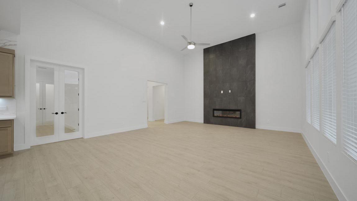 Spacious living area with vinyl flooring