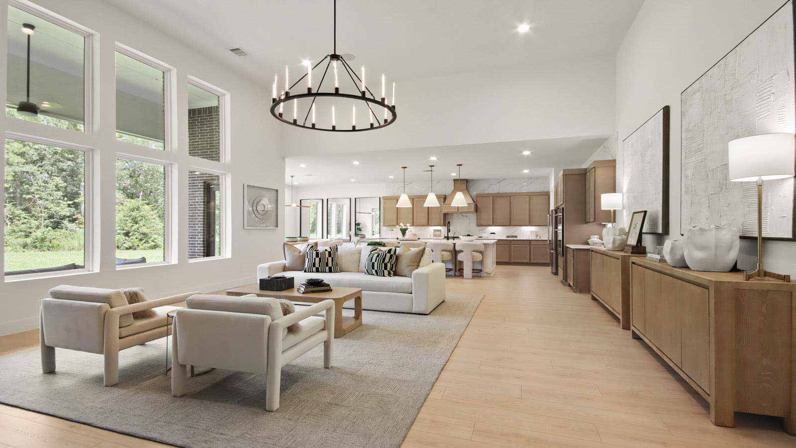 Open concept living, dining, and kitchen area with vinyl flooring and bright windows with floor to ceiling fireplace