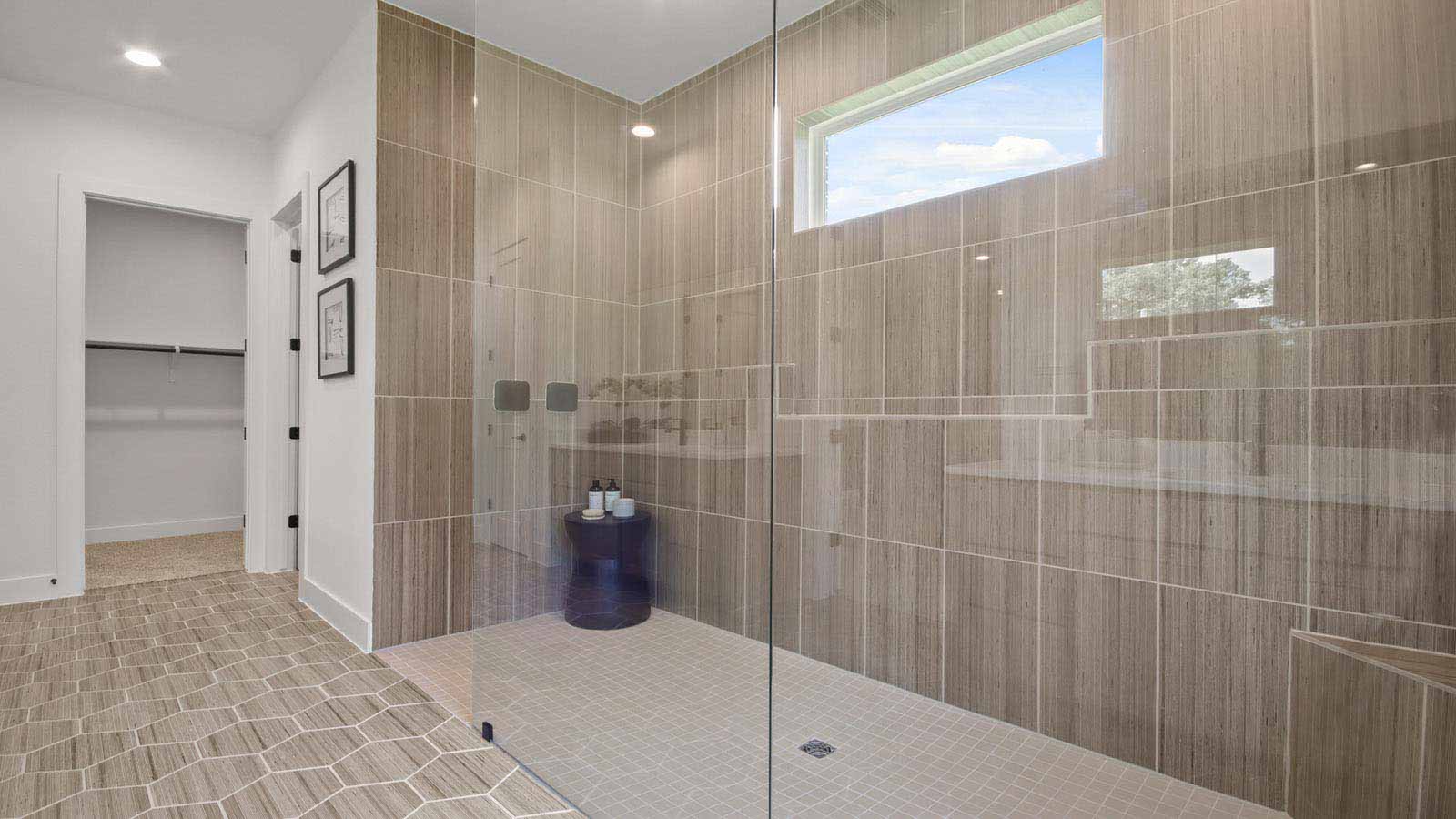 Primary bathroom with super shower with tiled wall and semi frameless glass in Pinehurst  TX