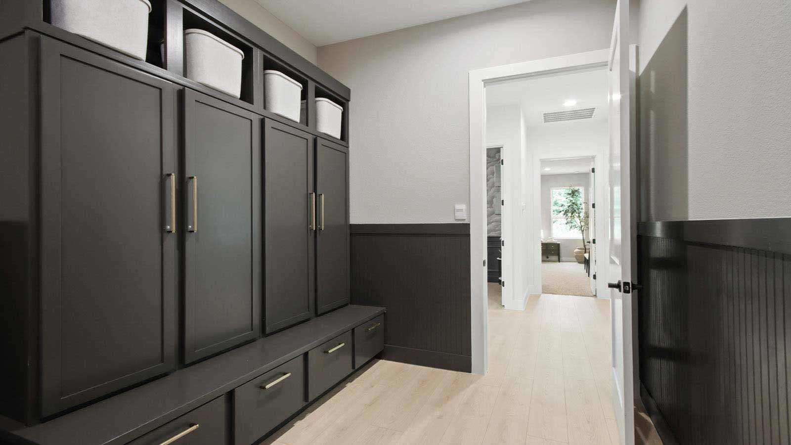 Utility room with storage and mud room located off the entry hallway and garage door