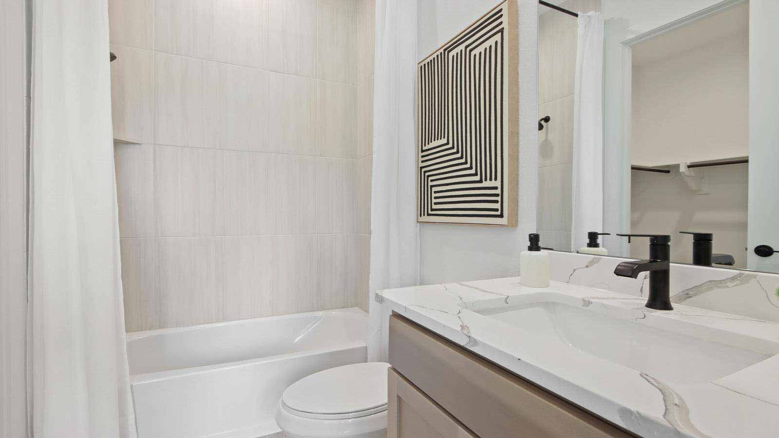 Secondary bathroom with stand alone shower with tile and semi frameless glass quartz counter tops in Pinehurst  TX