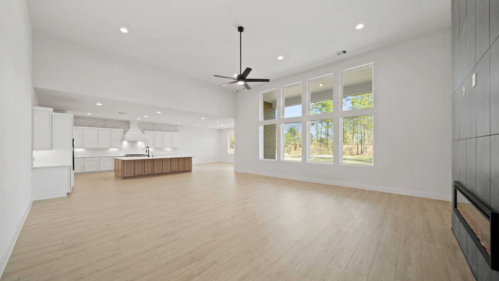 Spacious living area with vinyl flooring