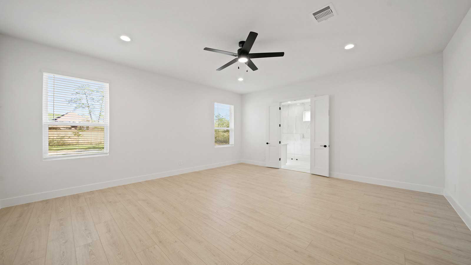 Primary bedroom with carpet flooring