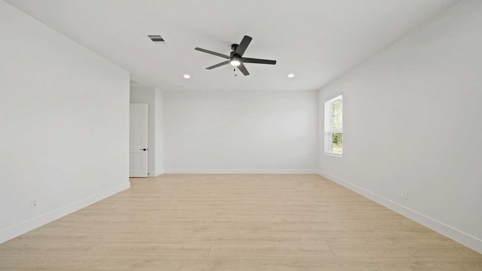 Primary bedroom with carpet flooring