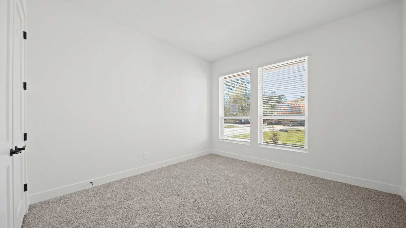 Secondary bedroom with carpet flooring