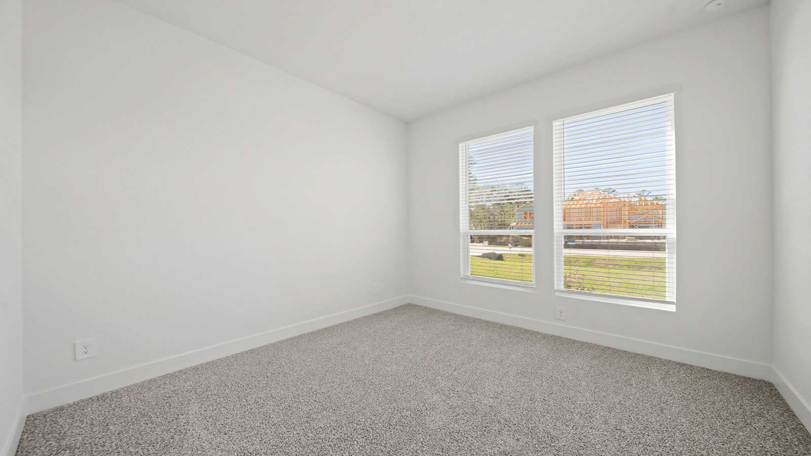 Secondary bedroom with carpet flooring