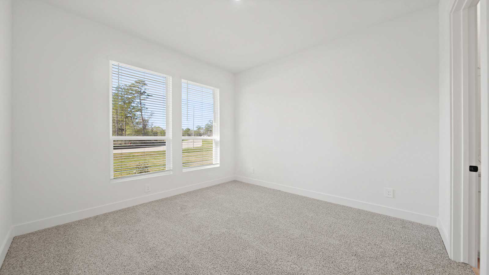 Secondary bedroom with carpet flooring