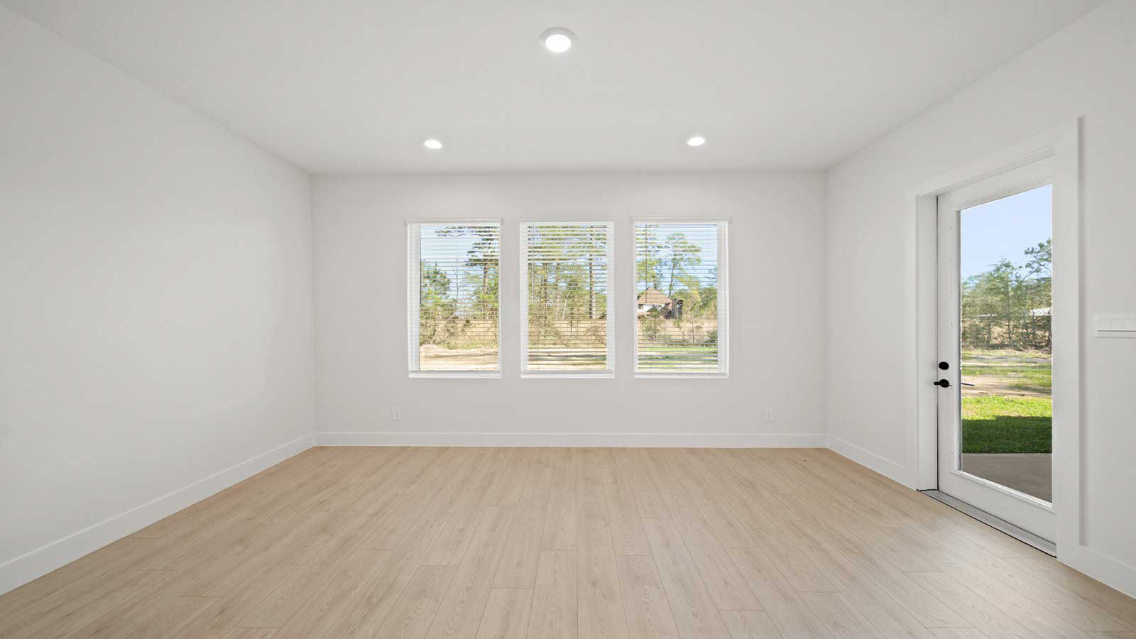 Spacious living area with vinyl flooring