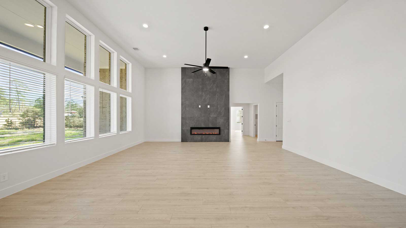 Spacious living area with vinyl flooring