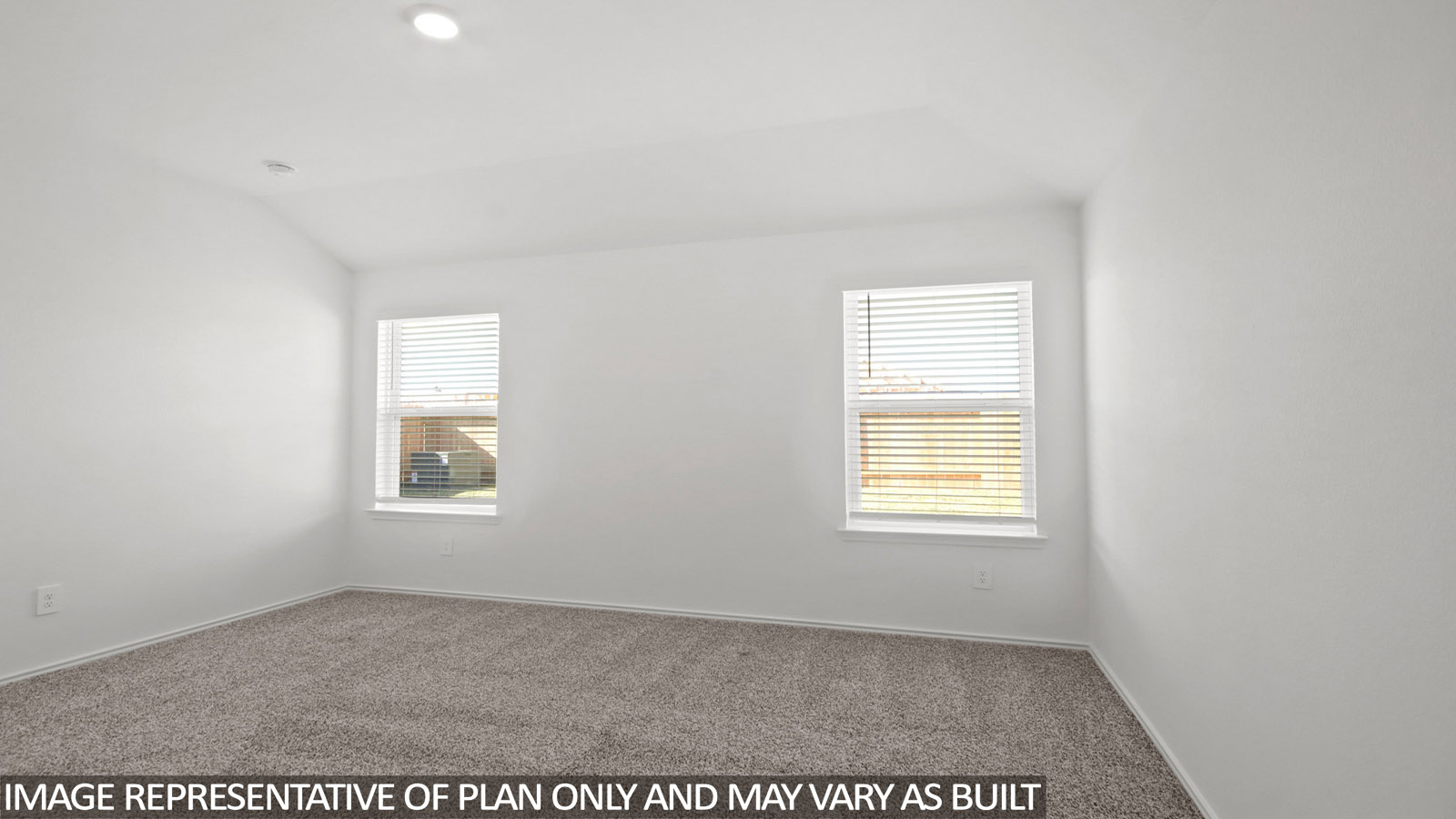 Primary bedroom with carpet flooring and two bright windows.