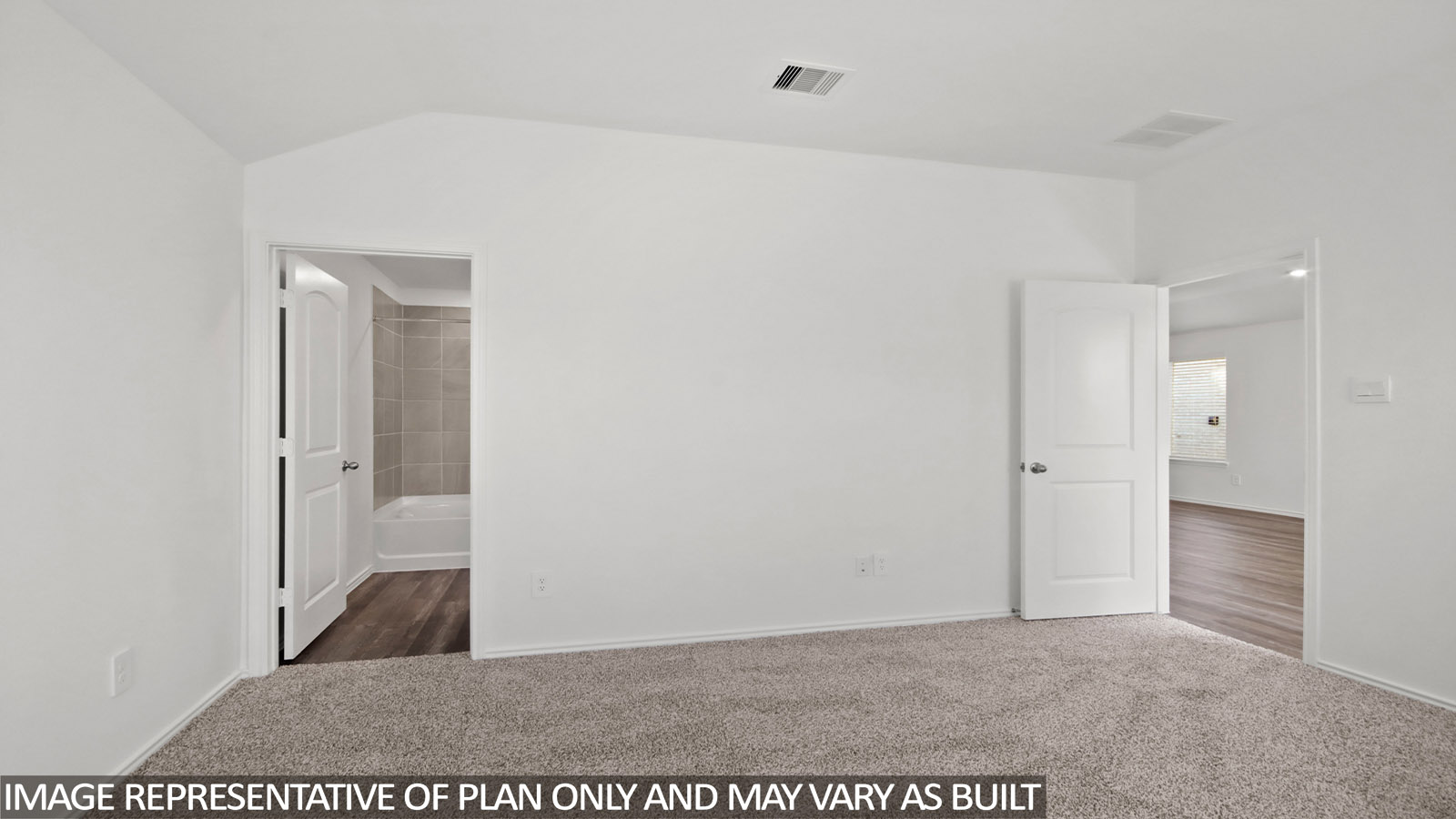Primary bedroom with carpet flooring.