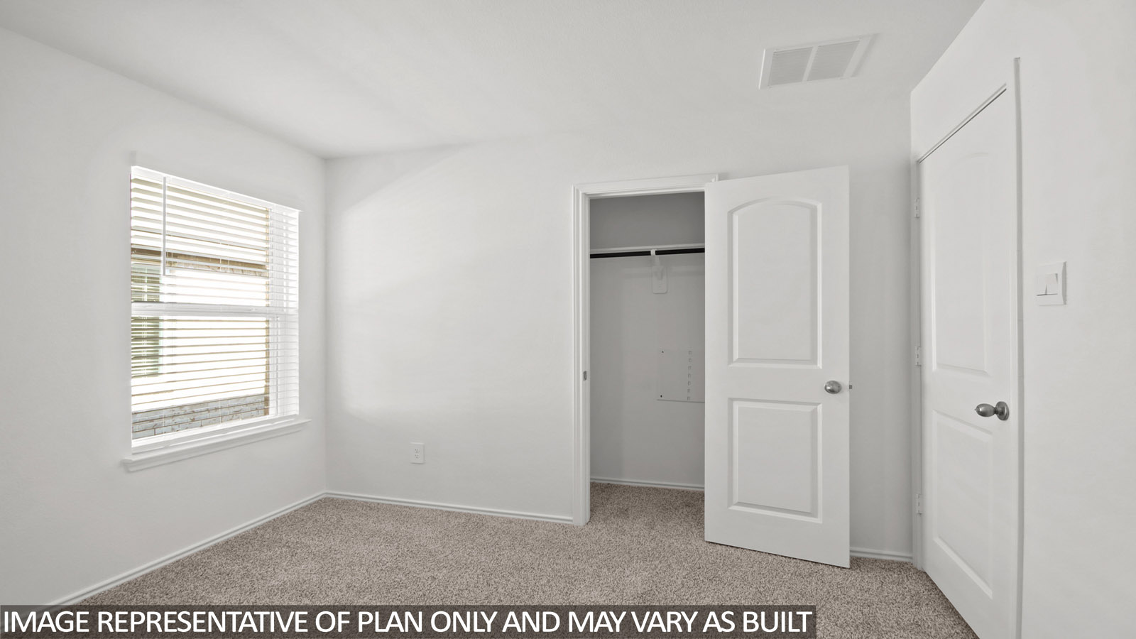 Secondary bedroom with carpet flooring and a bright window.