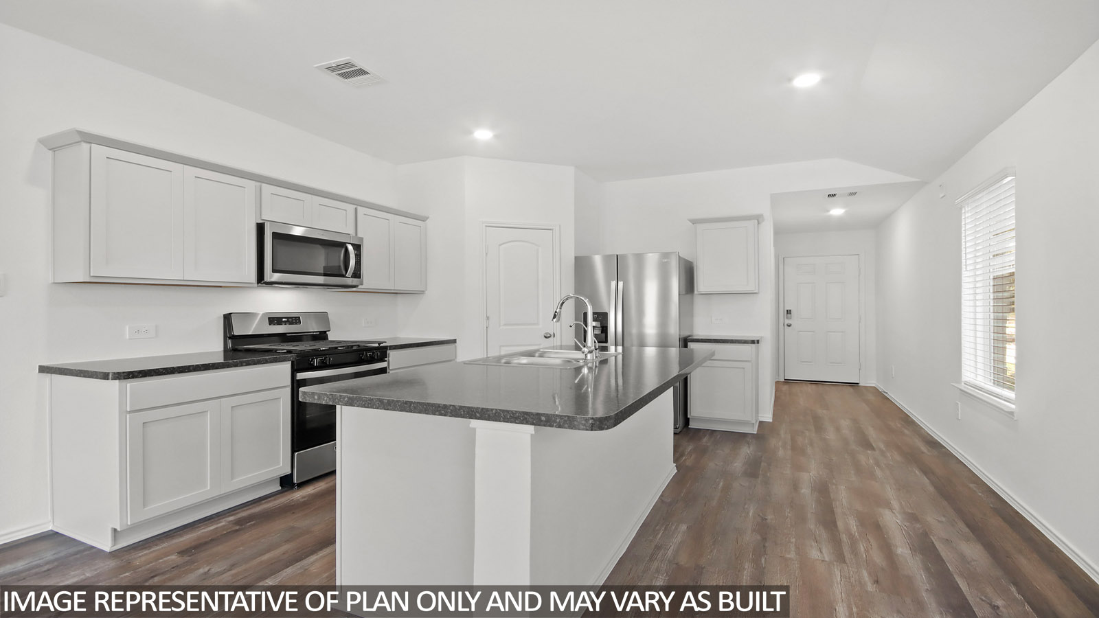 Kitchen with island and stainless-steel appliances.