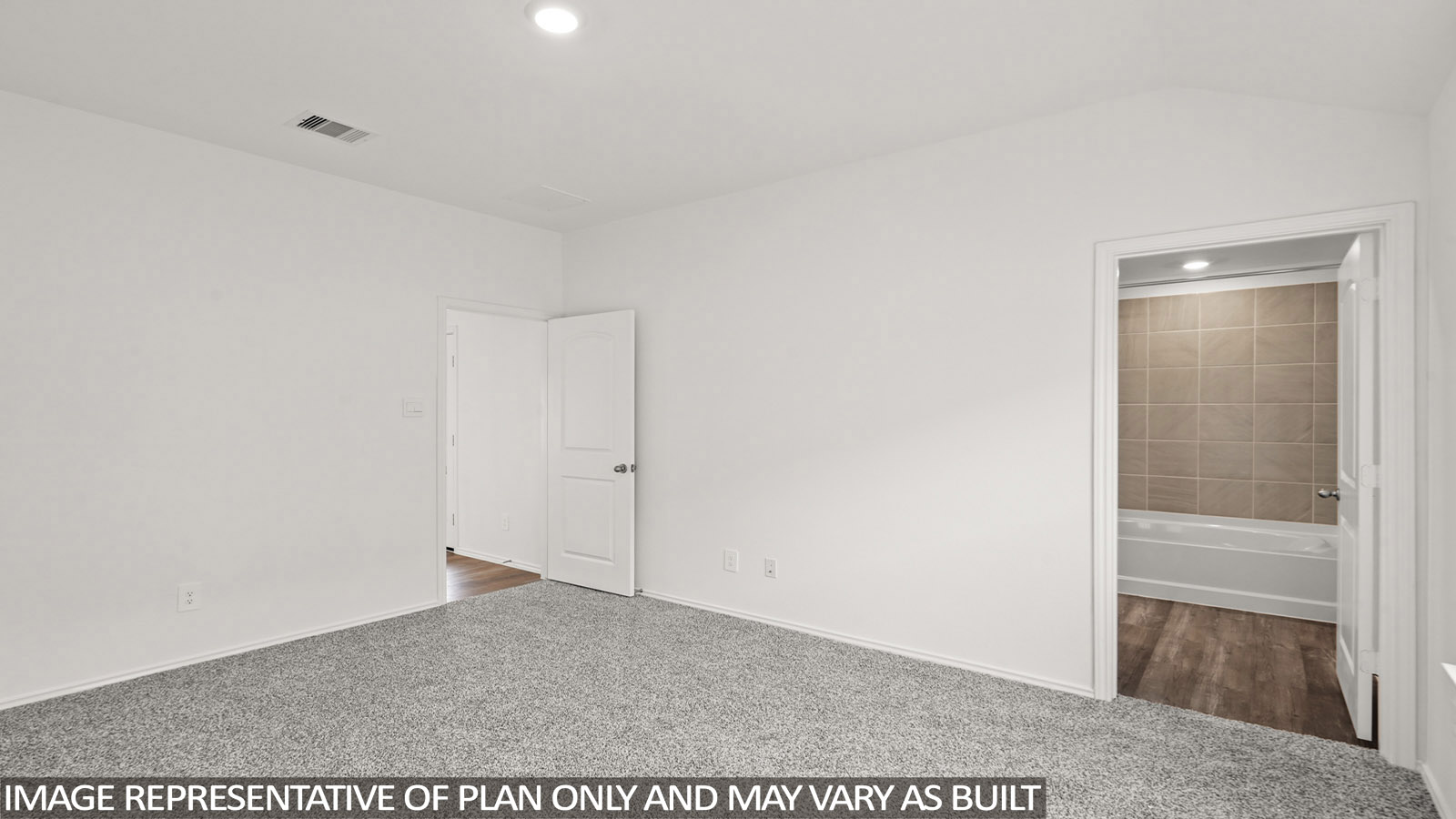Primary bedroom with carpet flooring.