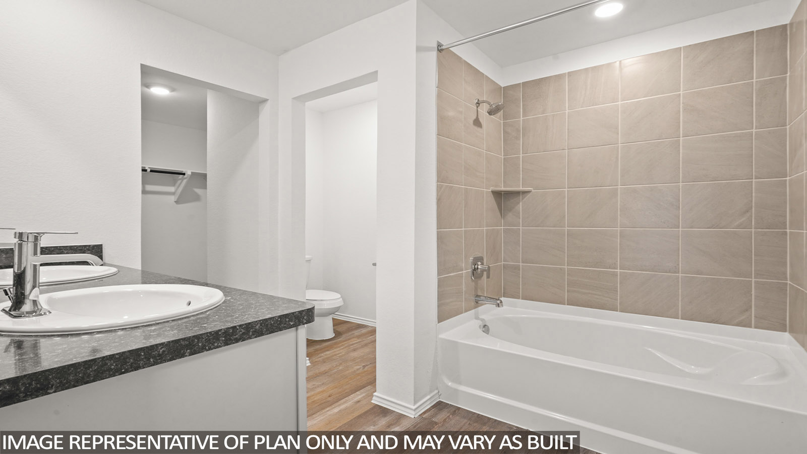 Primary bathroom with a tile tub/shower combo and a separate toilet room.