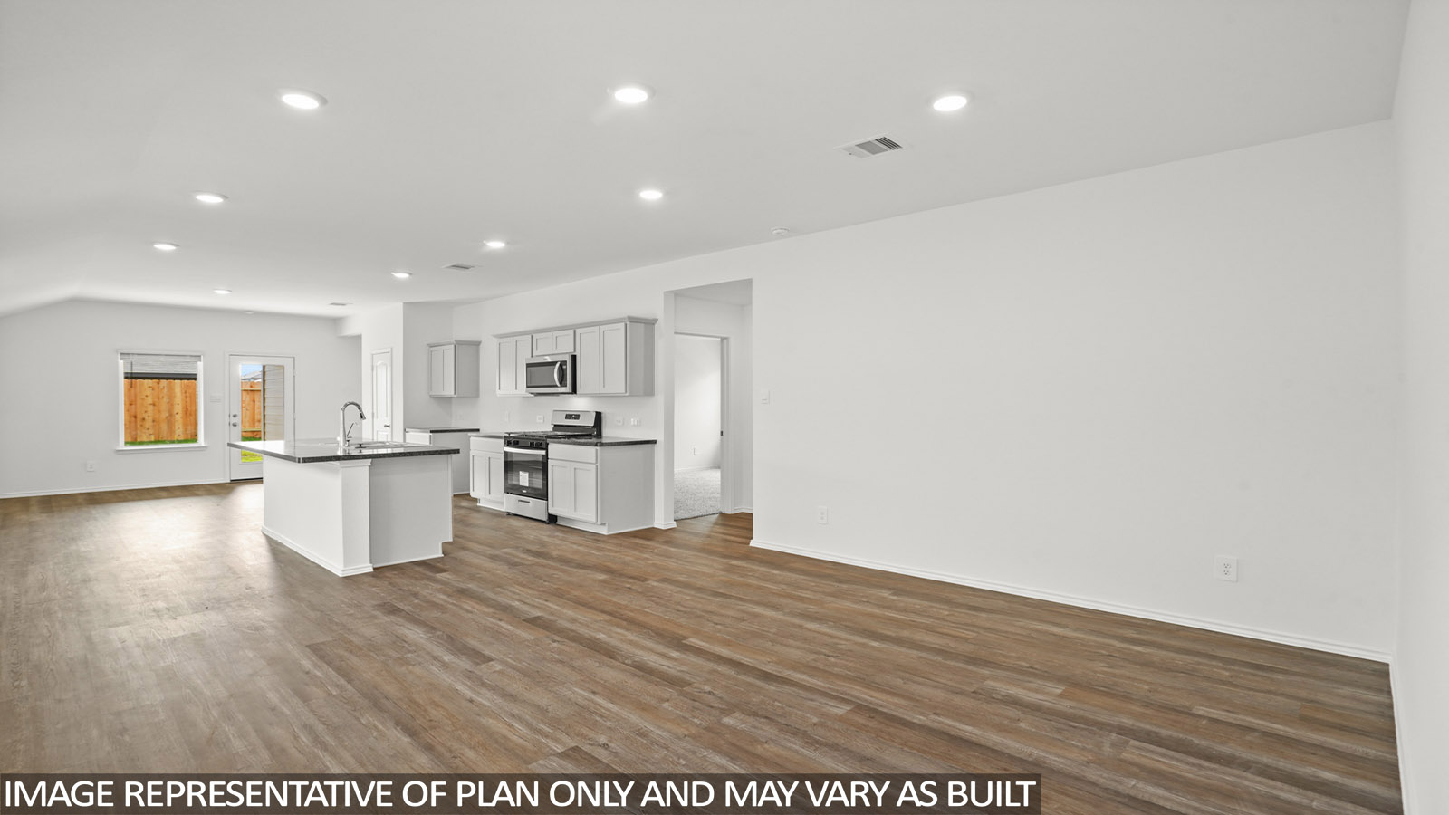 Open concept living and dining space with vinyl flooring.