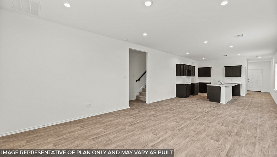 open concept living area with vinyl flooring and large windows