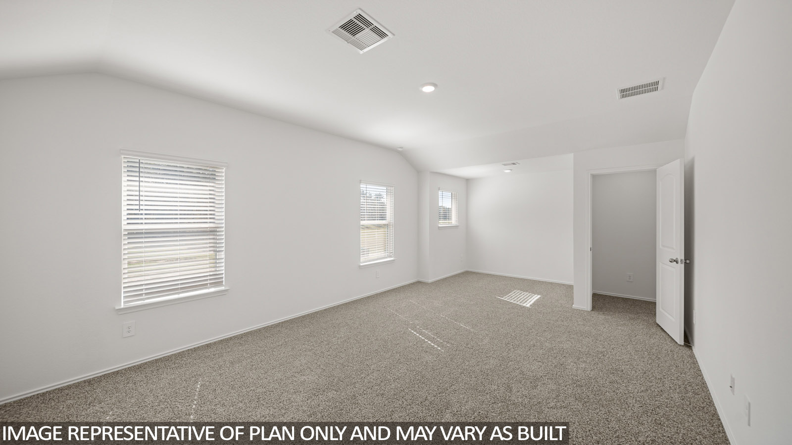 Primary bedroom with carpet flooring and two bright windows.