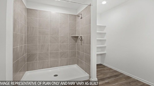 Stand up shower next to built in shelves