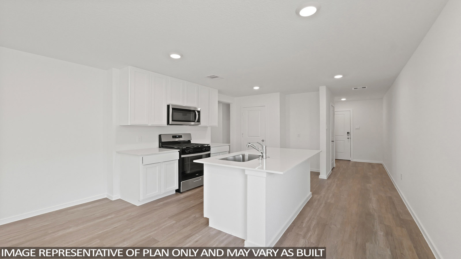 open concept living and dining area with vinyl flooring, stainless steel appliances, and quartz countertops in Hockley, Tx