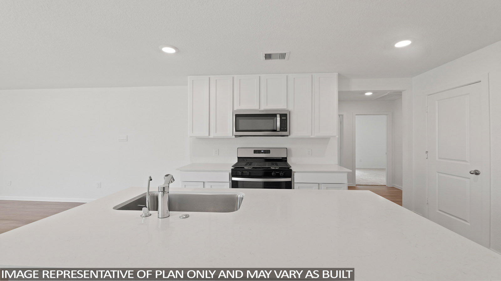 open concept living and dining area with vinyl flooring, stainless steel appliances, and quartz countertops in Hockley, Tx