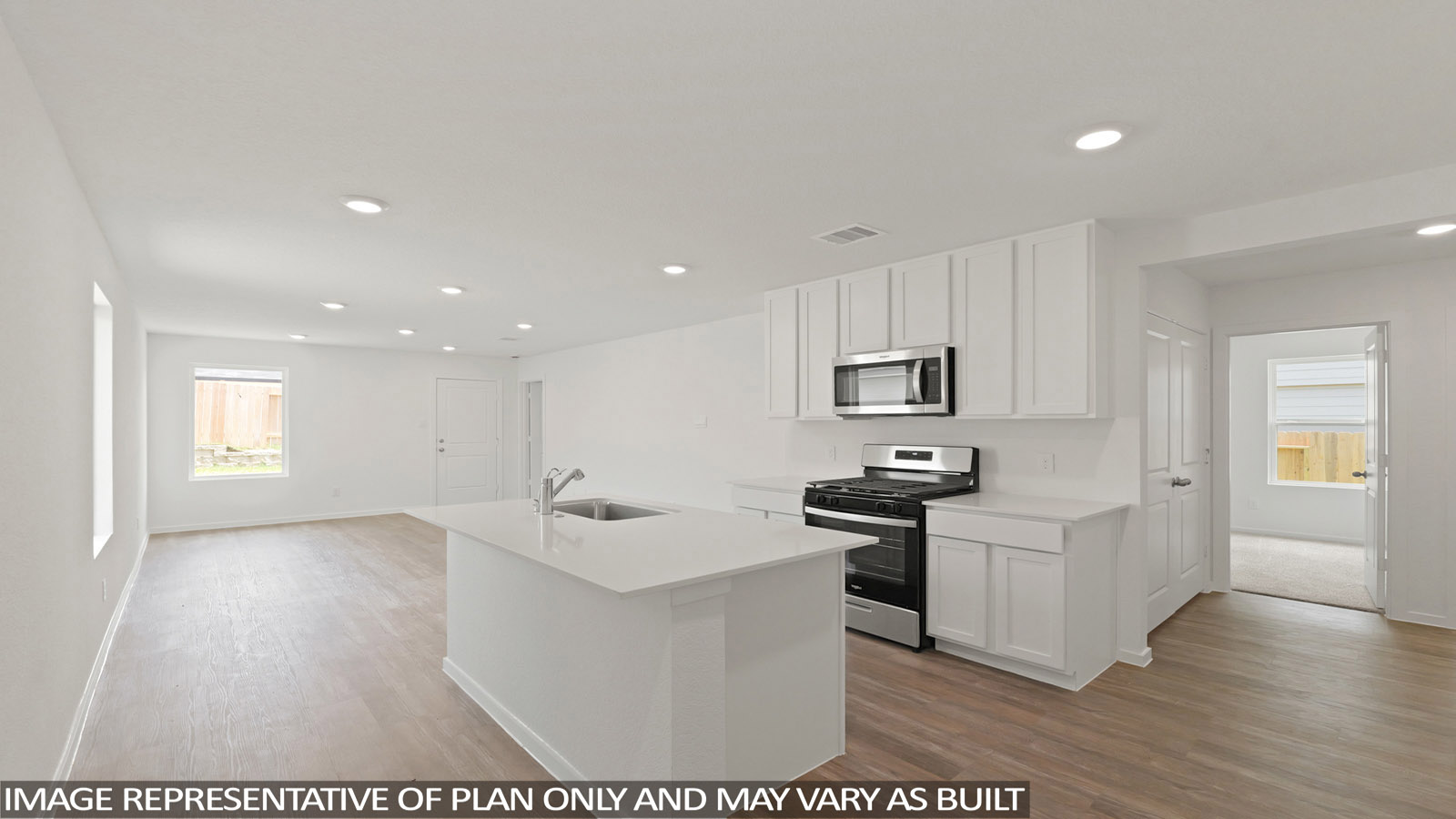 open concept living and dining area with vinyl flooring, stainless steel appliances, and quartz countertops in Hockley, Tx