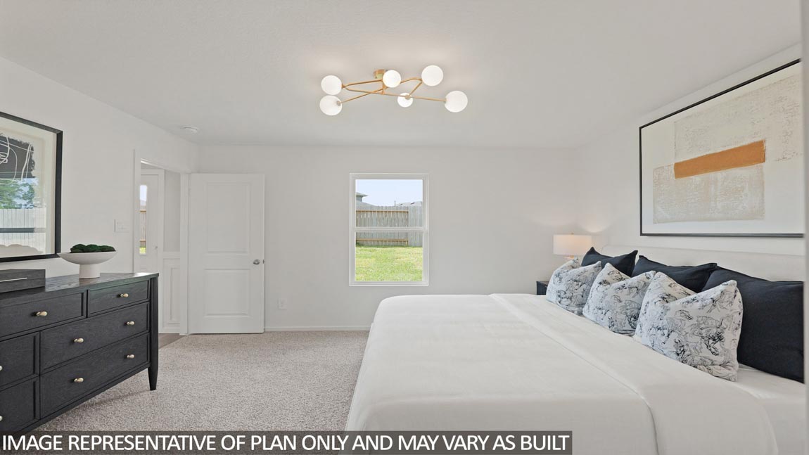 Large Primary bedroom with shag carpet flooring and bright window