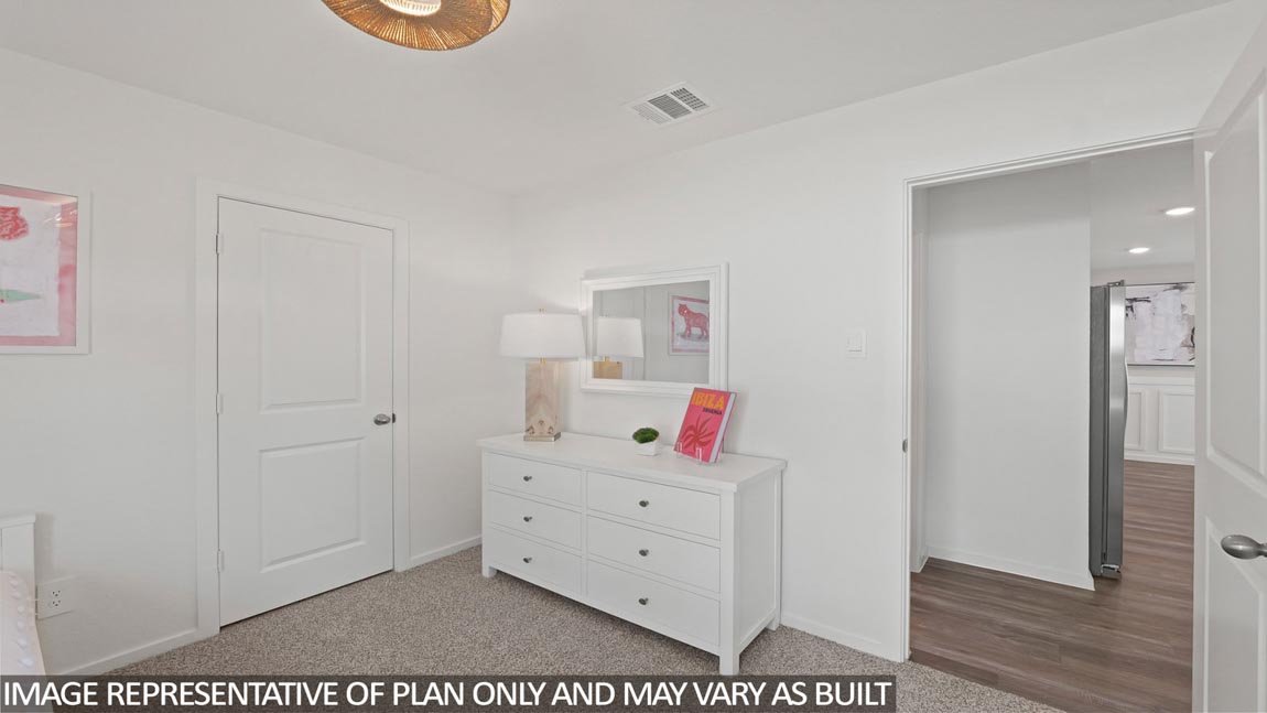 Secondary bedroom with shag carpet flooring and bright window