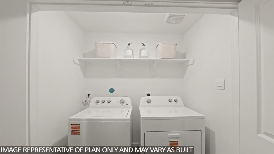 Utility room with storage located off the entry hallway and garage door