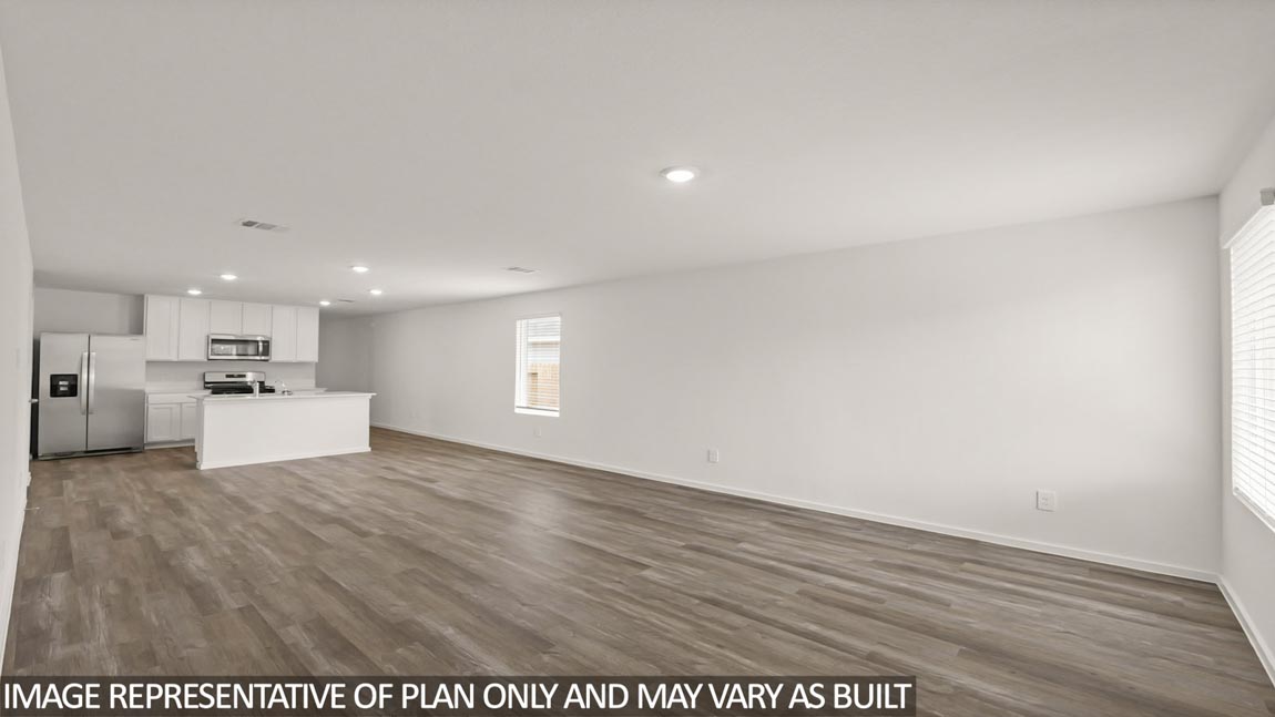 open concept living and dining area with vinyl flooring and large windows
