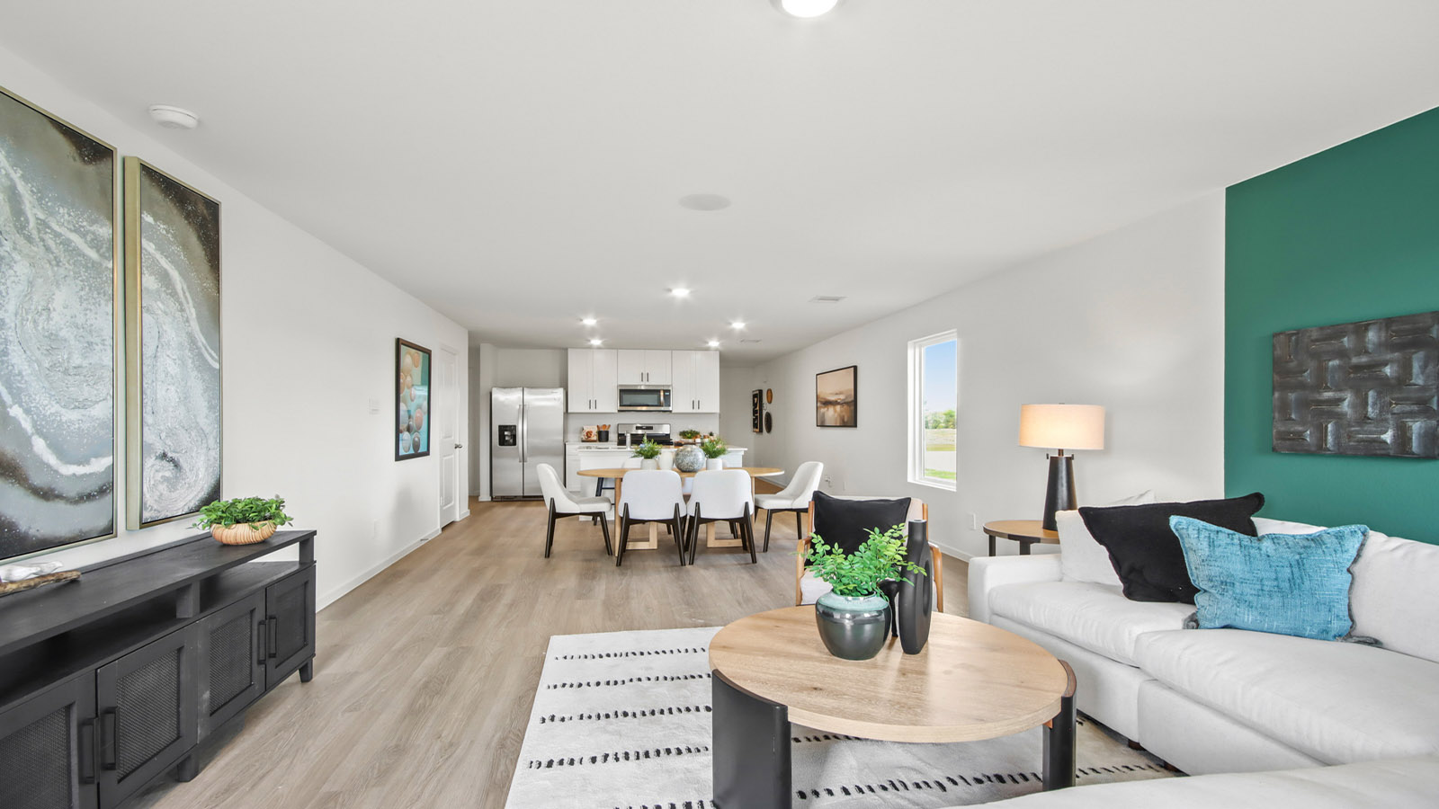 open concept livving and dining area with vinyl flooring and large windows